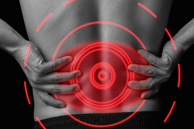 Acute pain in a male lower back, black and white image, pain area of red color